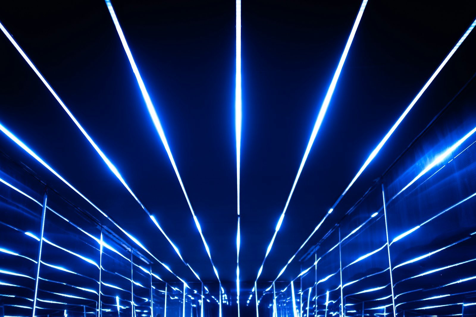 Abstract light trails on a dark background, illustrating an article on AI, autonomous systems and international humanitarian law